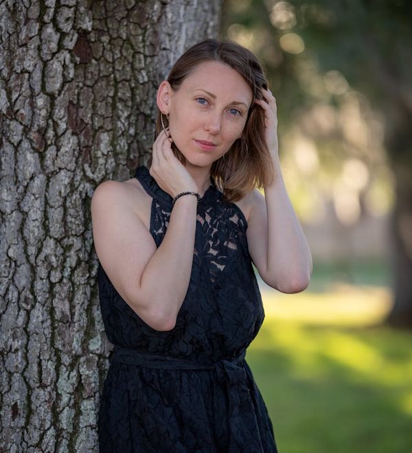 Woman in a serene yoga pose with a calm expression on her face.